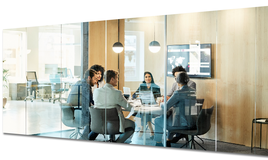 A group of people are sitting around a table in a conference room.