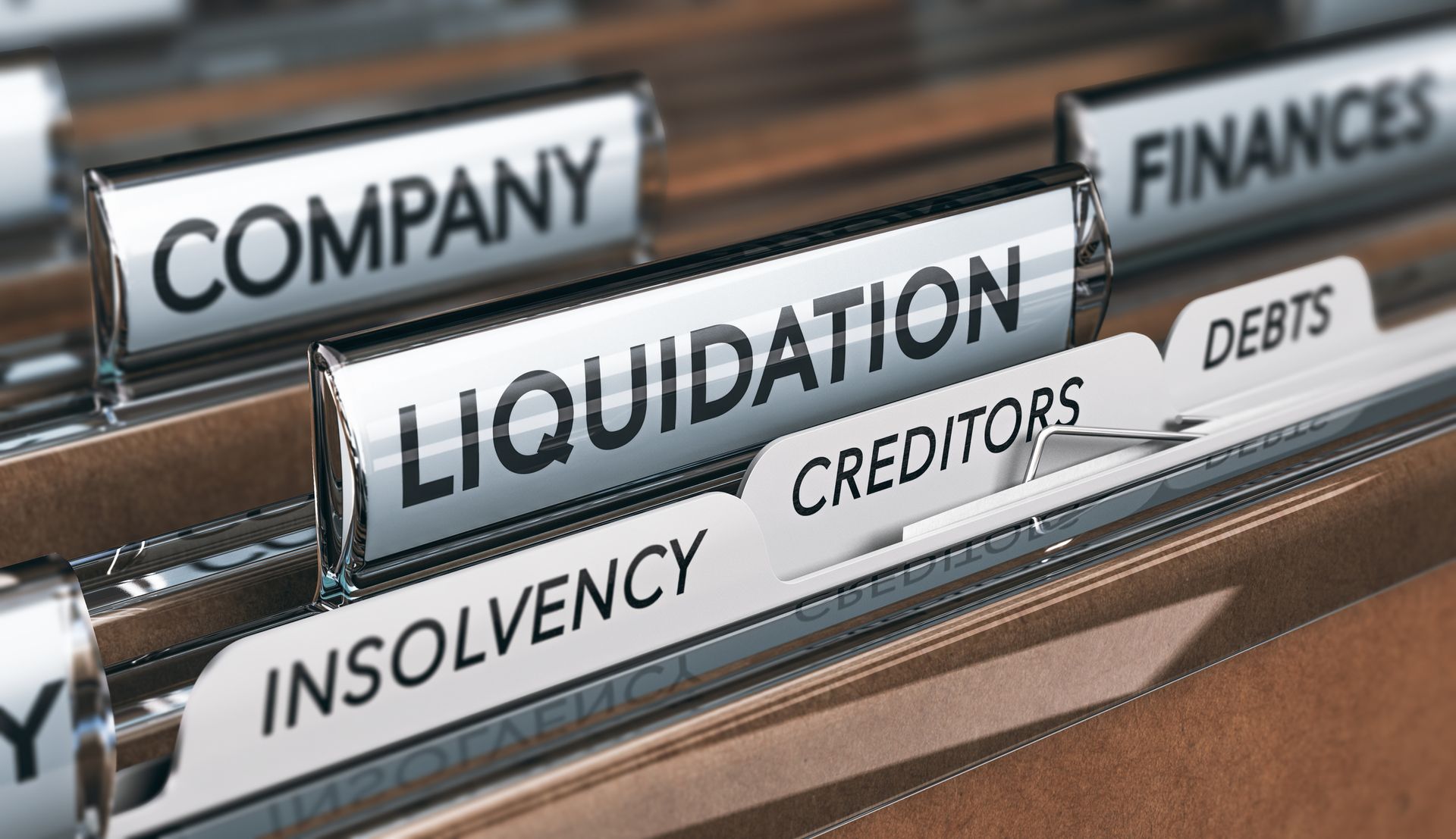 Company liquidation concept. File and tabs with the word’s insolvency, creditors and debts.