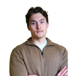 Man with light skin and blue eyes, wearing a brown zippered sweater, arms crossed.