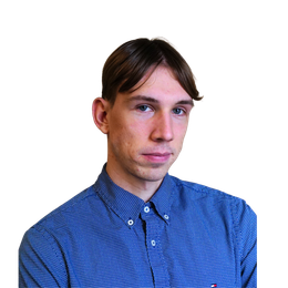 Man with light skin and short brown hair wearing a blue patterned button-up shirt, looking at the viewer.