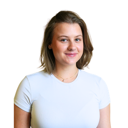 Woman with light brown hair smiles, wearing a white t-shirt and gold necklace, posing against a white background.