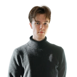 Man in a dark turtleneck sweater, looking at the camera against a white background.