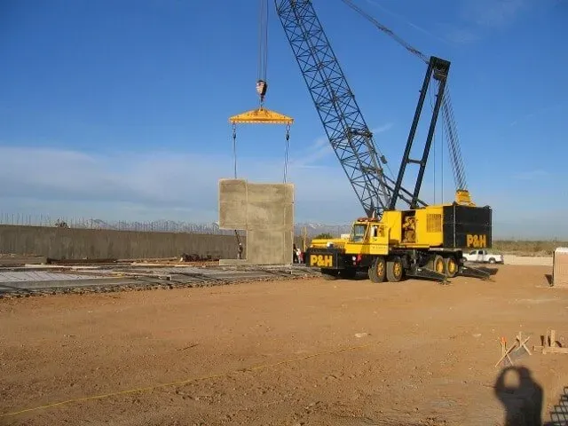 Construction site with equipment lifting material — Hesperia, CA — Bergstrom Construction