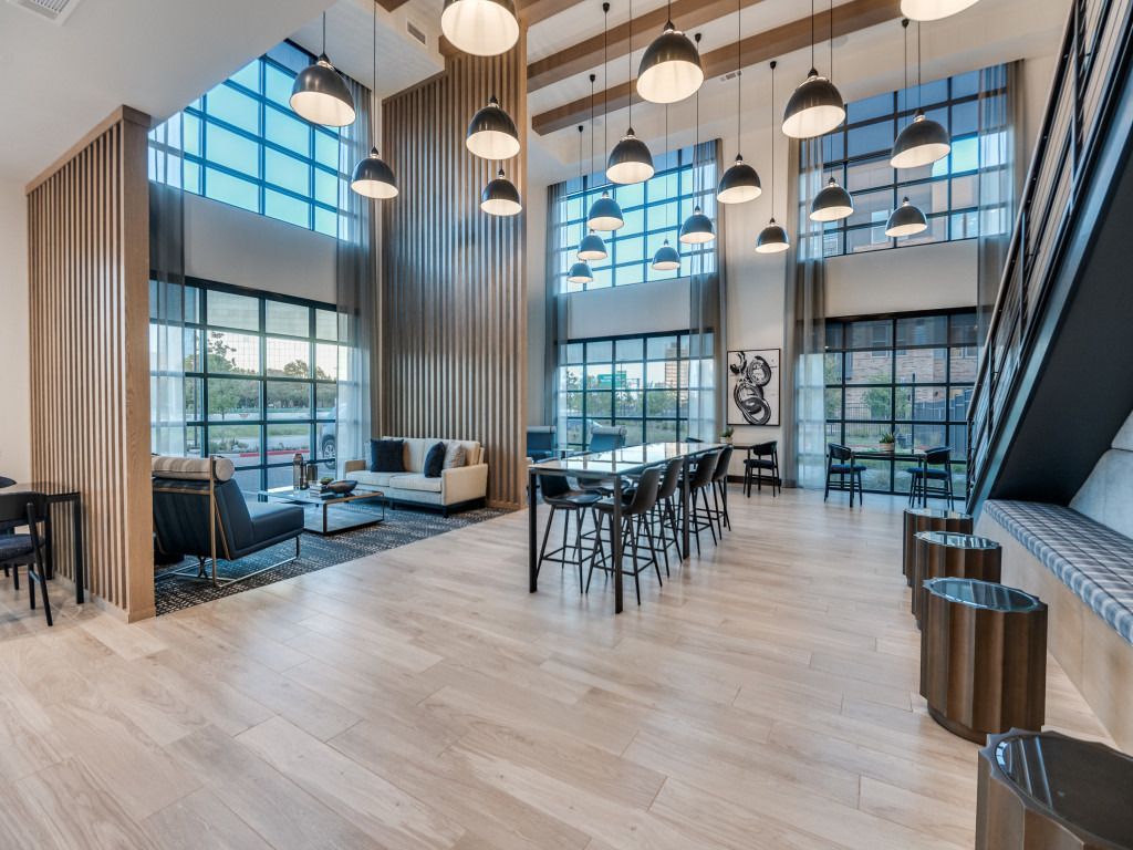A large room with a lot of windows and furniture in it.