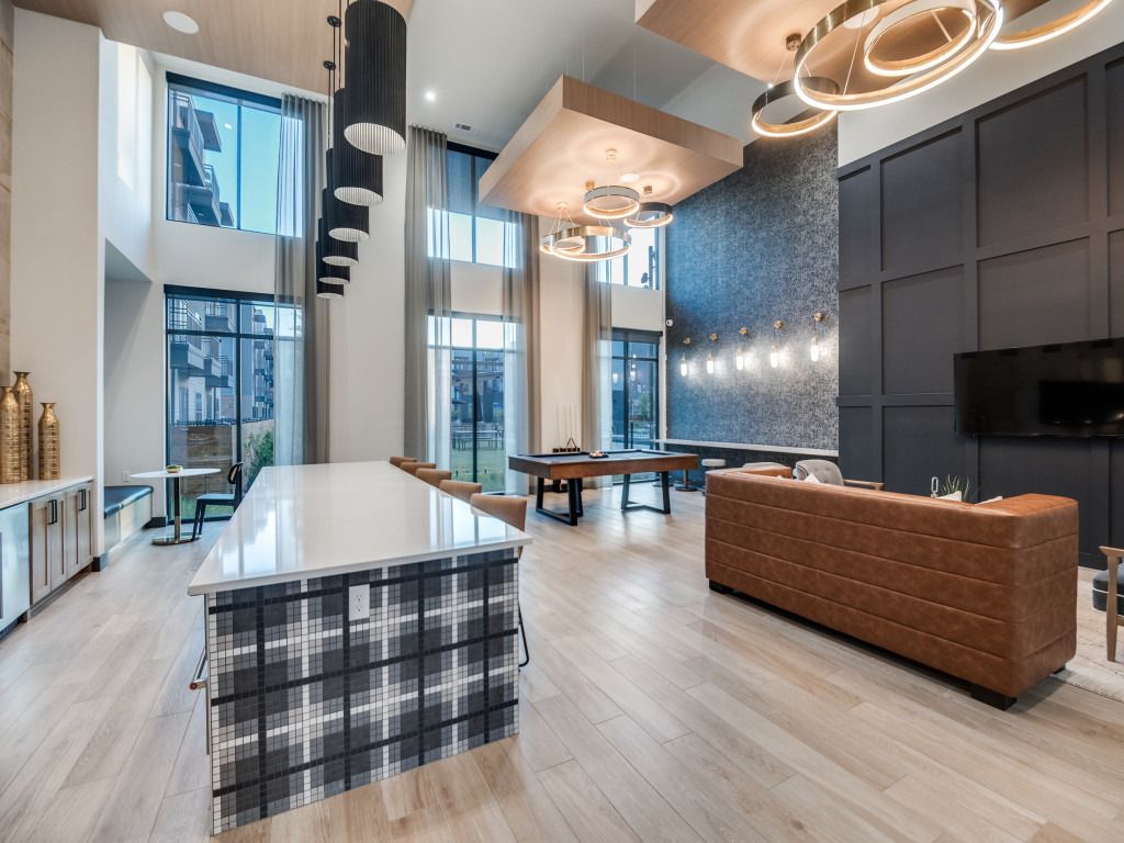 A living room with a pool table , couch , and television.