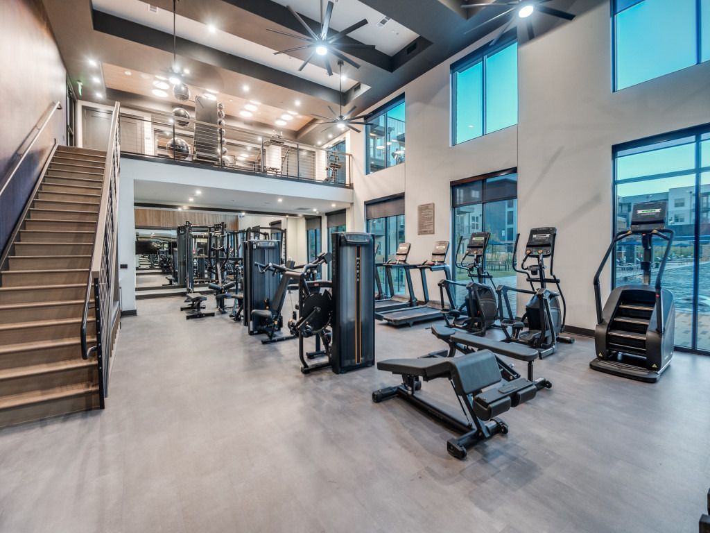 A large gym with a lot of equipment and stairs.