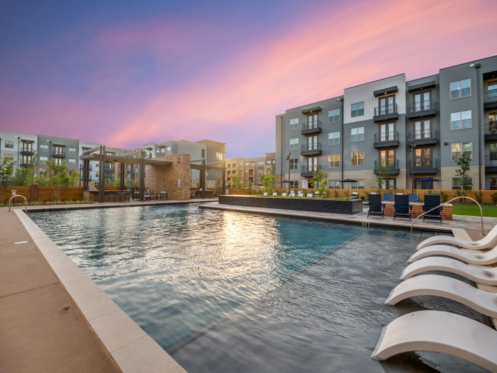 There is a large swimming pool in the middle of a building.