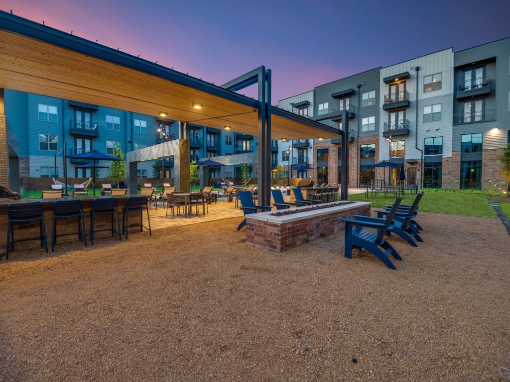 There is a fire pit in the middle of the courtyard of a building.