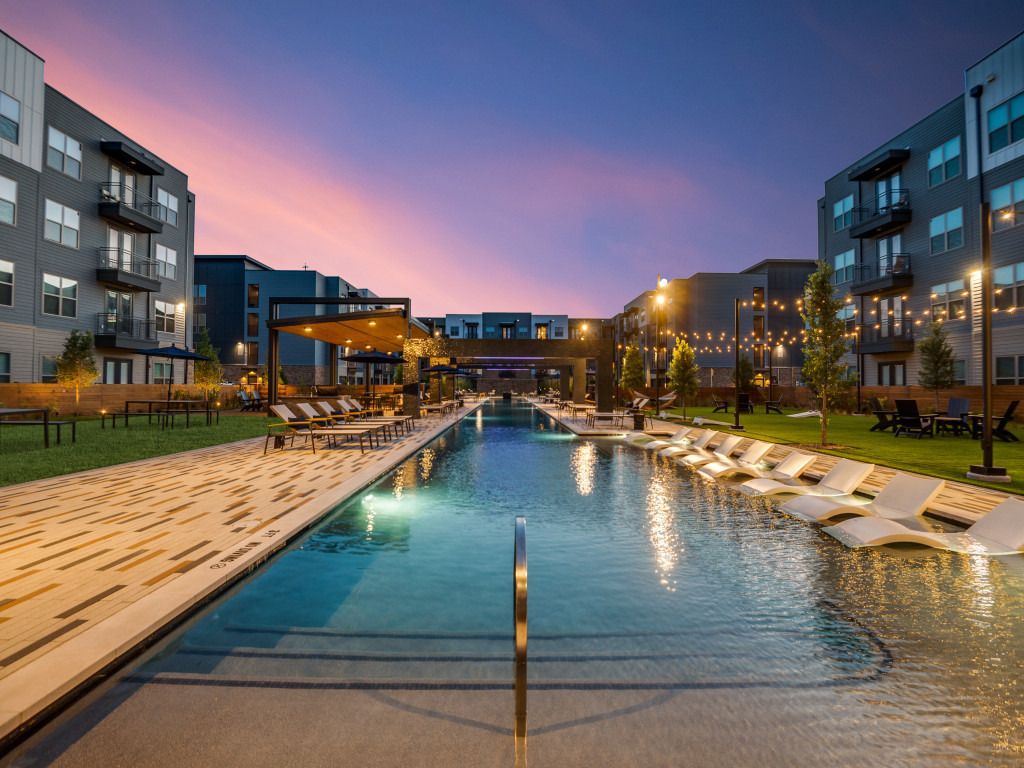 There is a large swimming pool in the middle of a building.