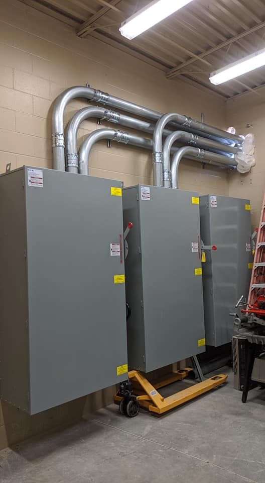 Family gathered at a dining table in a kitchen. They are eating and talking together.