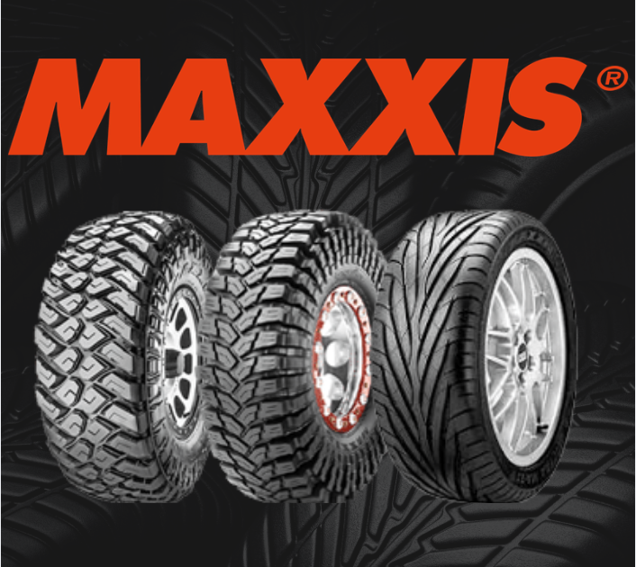 Two black tires standing against a dark, minimalist background.