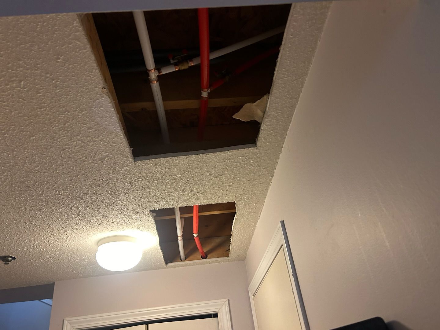 A room with a hole in the ceiling and a light