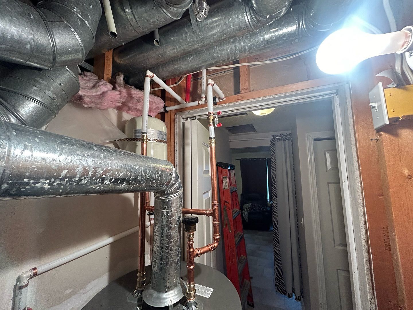 A room with a lot of pipes hanging from the ceiling.