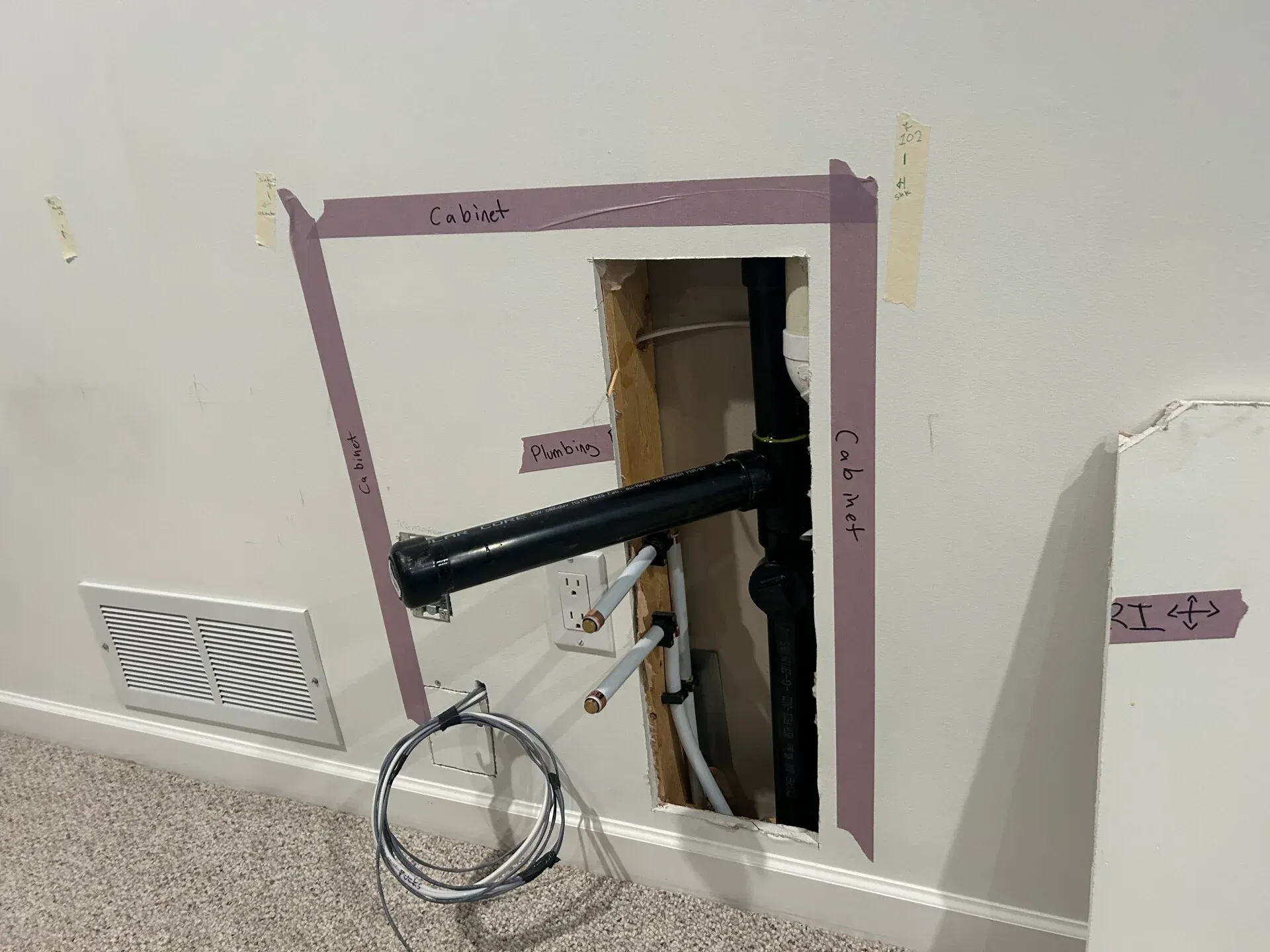 A hole in a wall with a pipe coming out of it.