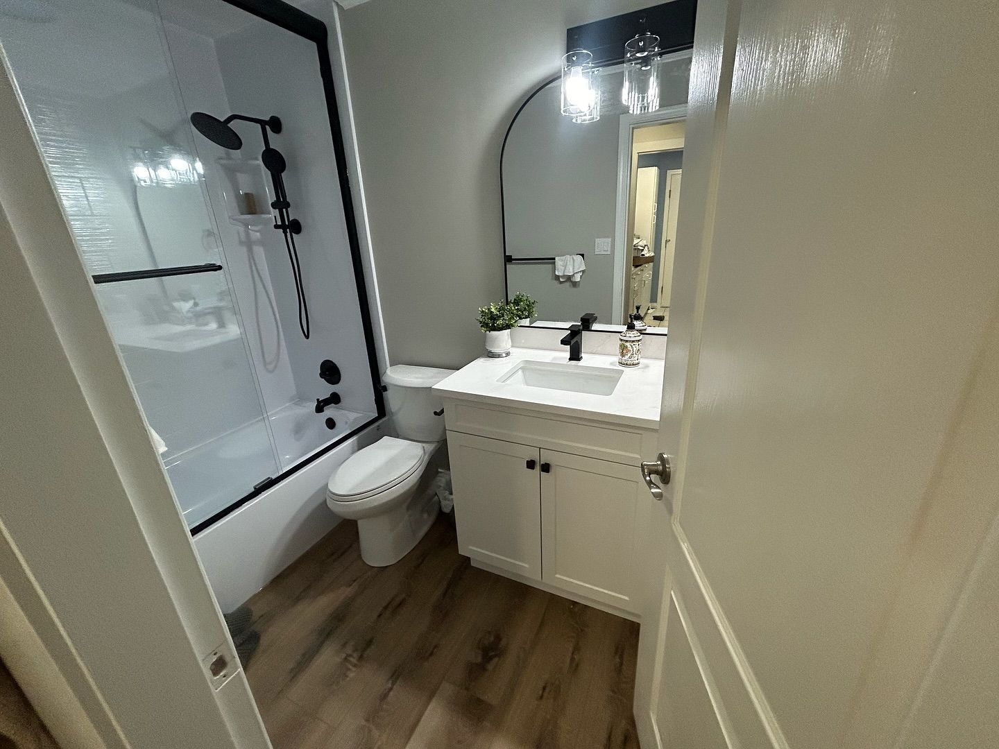 A bathroom with a toilet , sink , and shower.