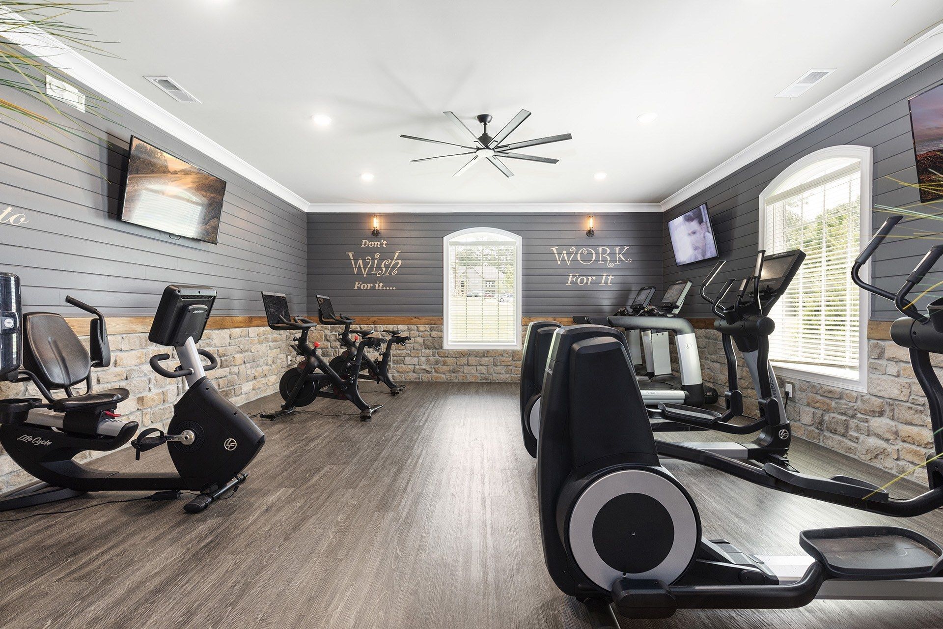Indoor fitness center with treadmills, bikes, and ellipticals.