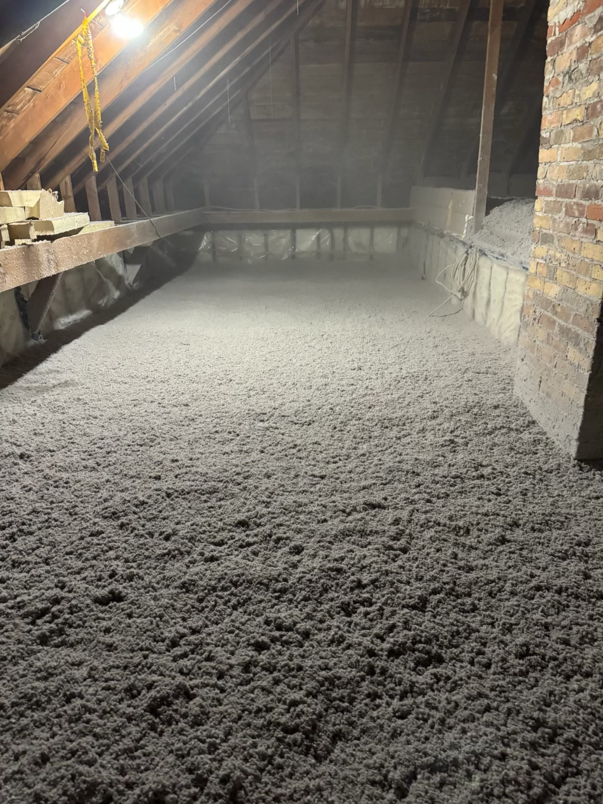 An attic with a lot of insulation on the floor
