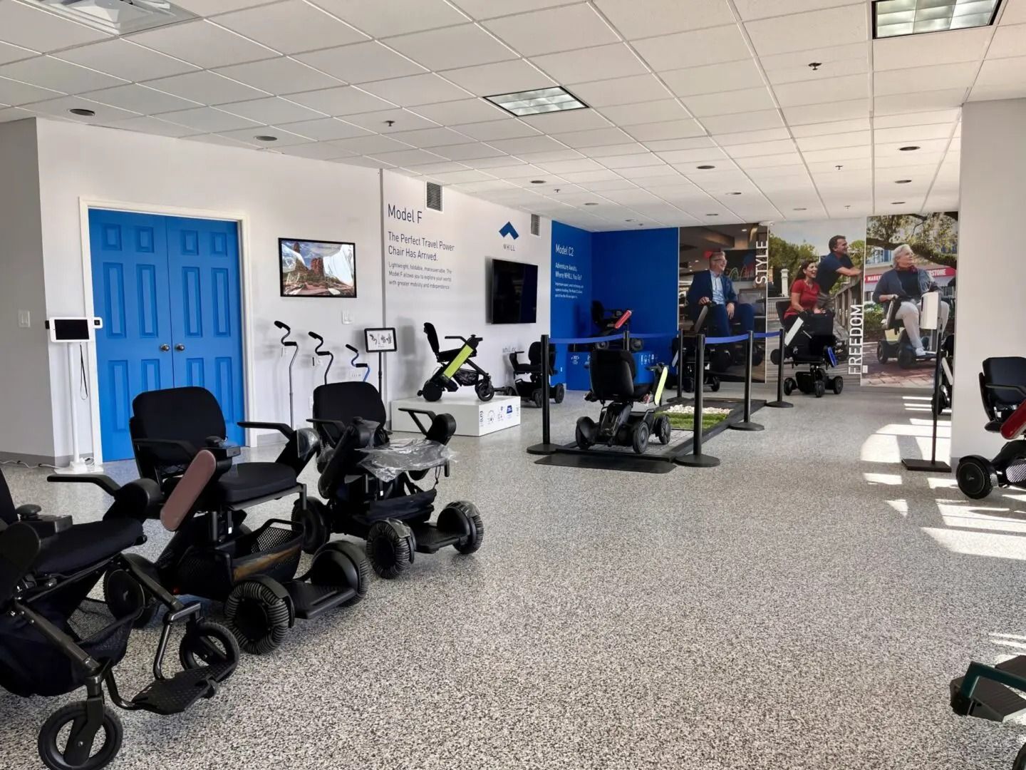Interior shot of a showroom with mobility aids like wheelchairs and scooters on display.