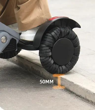 Hoverboard wheel ascending a 50mm curb; person's foot visible.