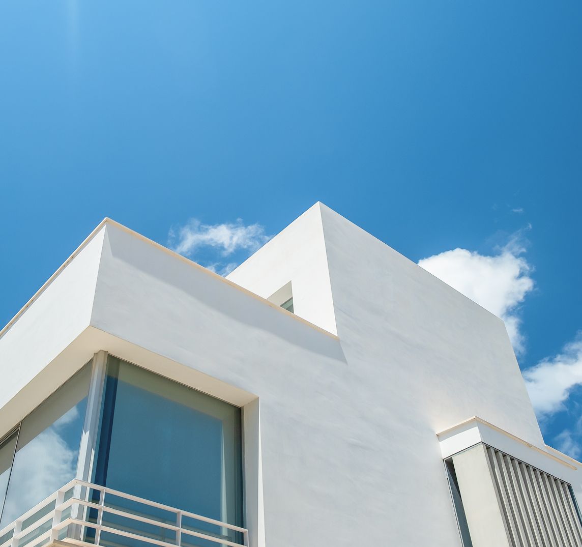 A white building with a blue sky in the background