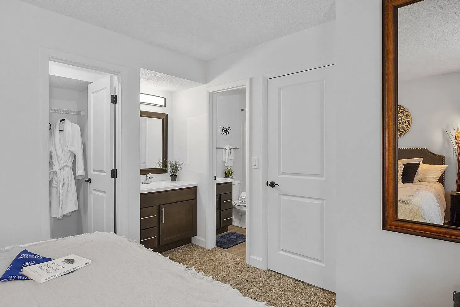 Tall Timber Apartments Bedroom with an adjacent bathroom vanity and closet in a modern apartment.