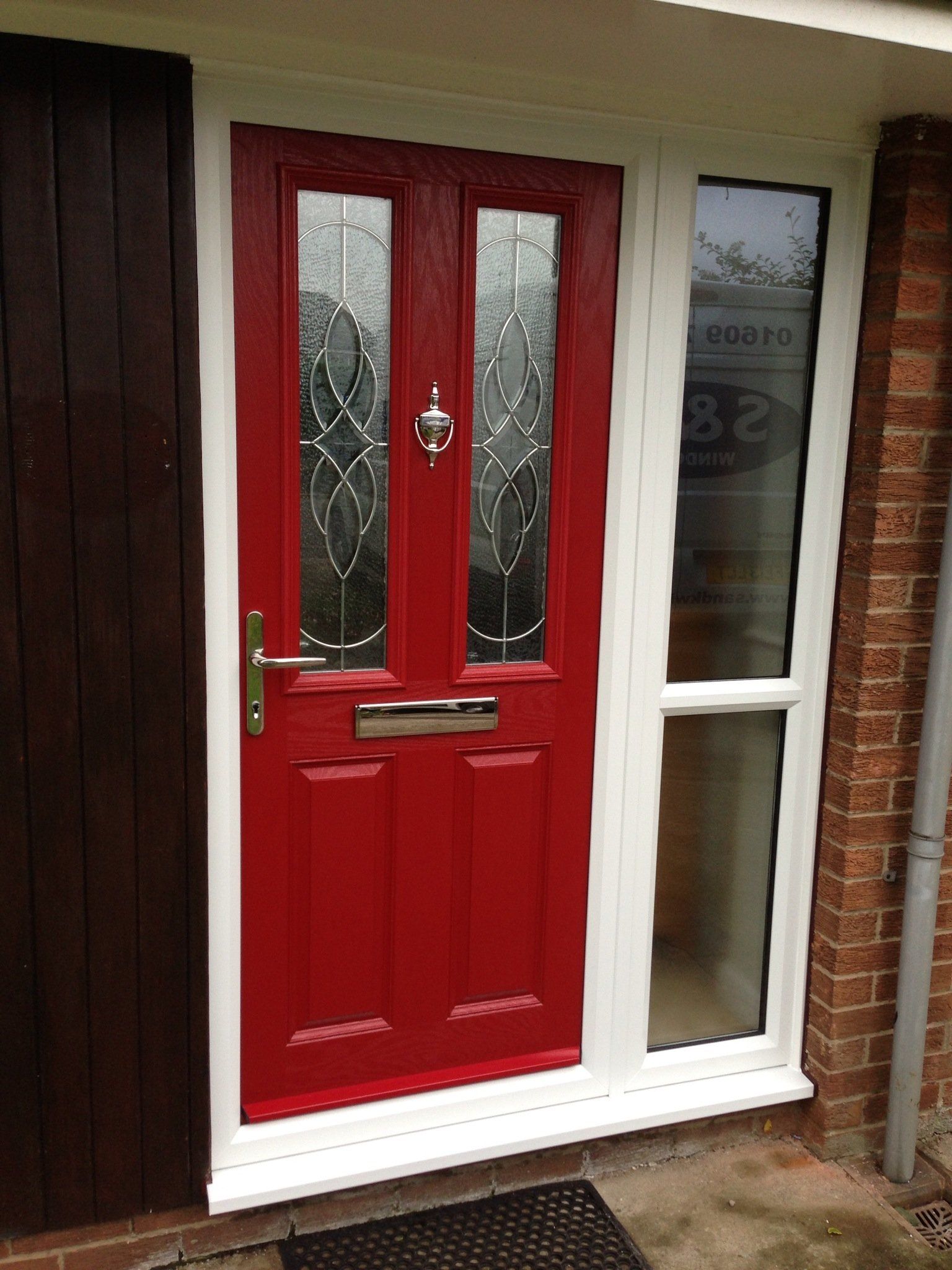 red composite door installed at the entrance