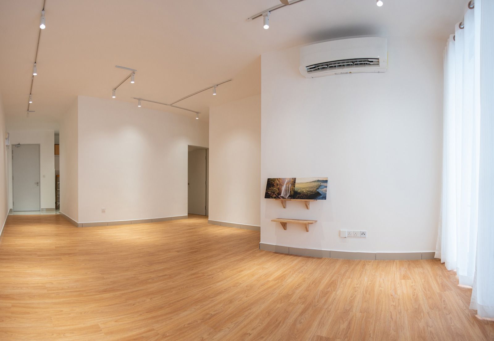 Gray, glossy floor reflecting sunlight and surrounding objects, possibly a patio or sunroom.