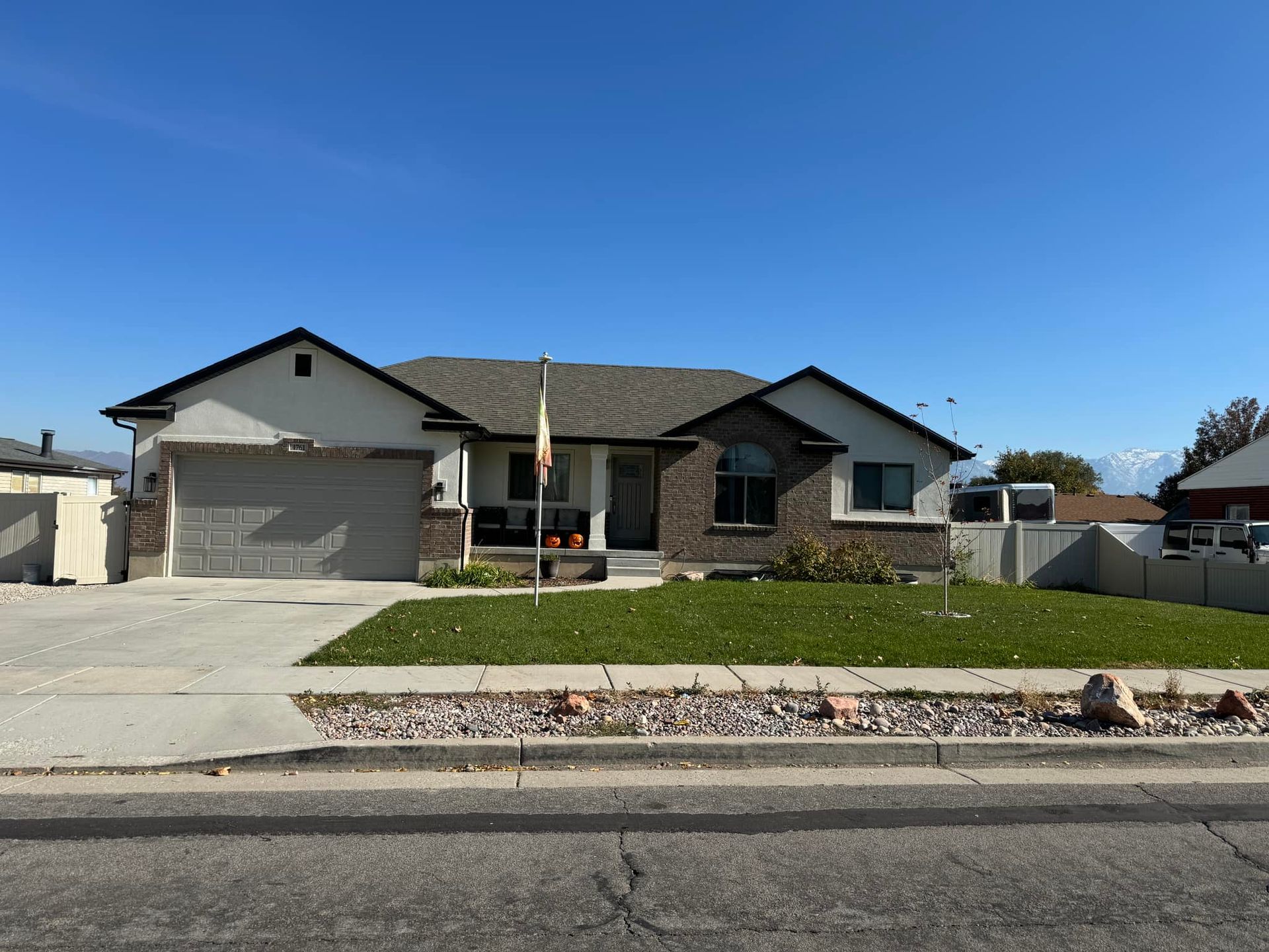 The front of a house with a flag on the porch