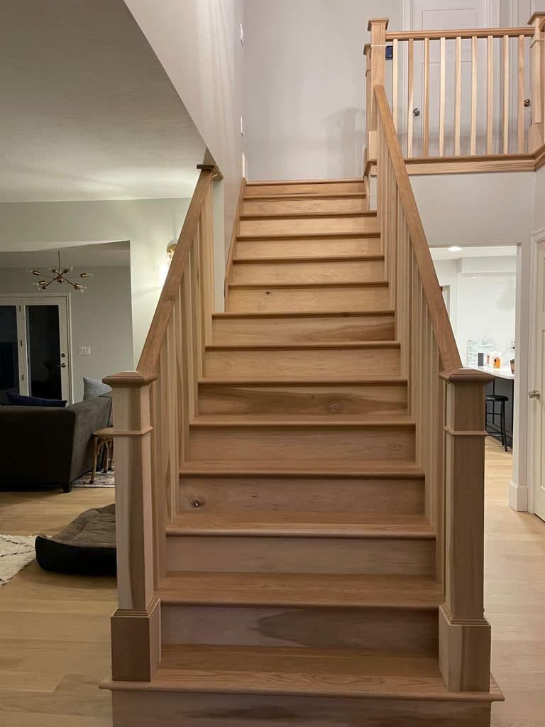 A wooden staircase leading up to a second floor in a house.