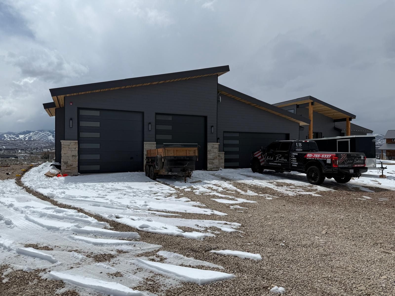 A kitchen with gray cabinets and a large island in the middle.