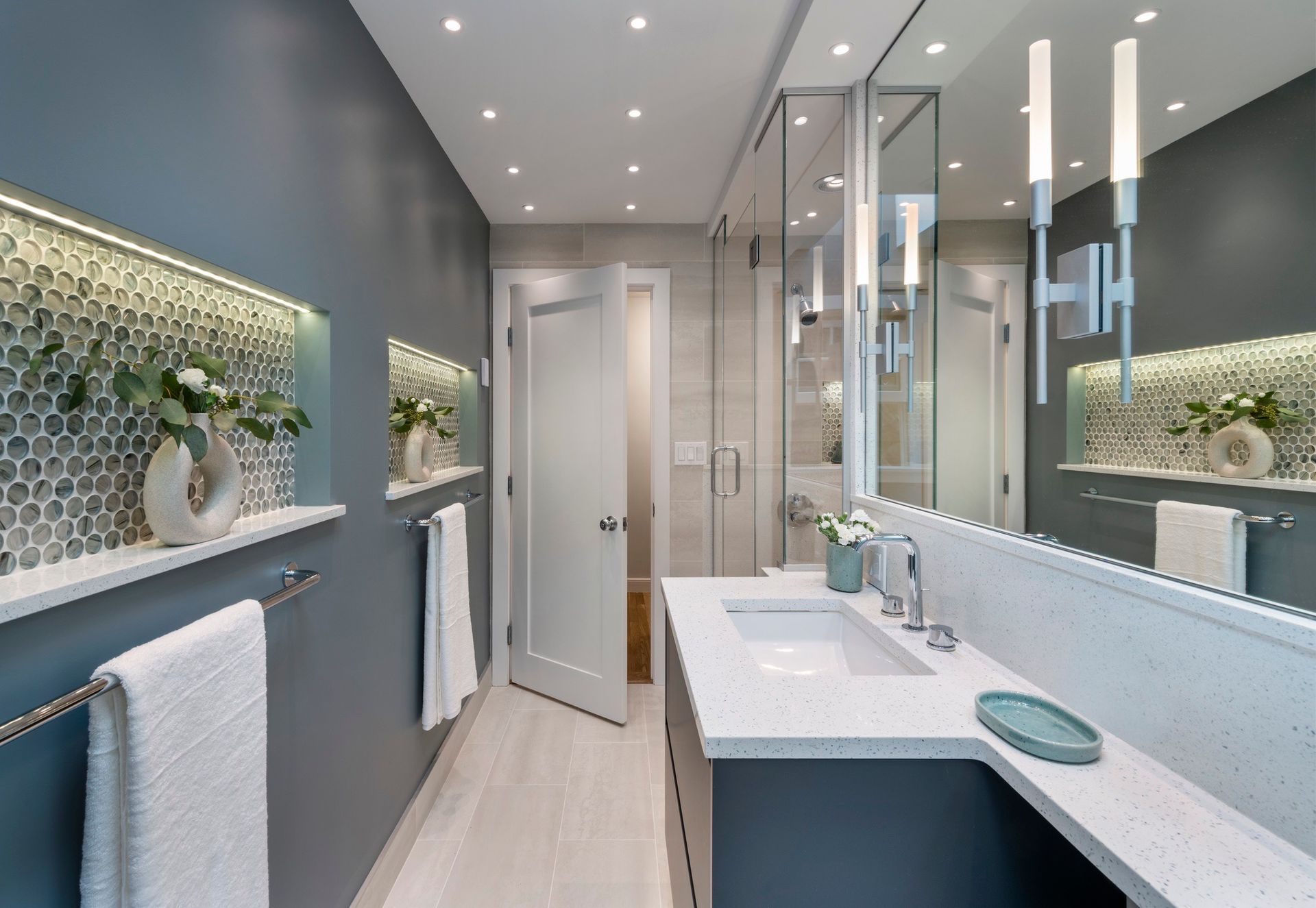 A bathroom with two sinks and a large mirror