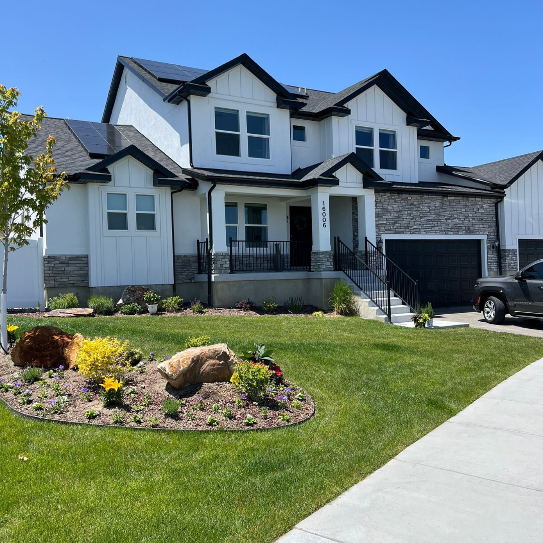 A patio with a pergola and a dining area in the backyard of a house.