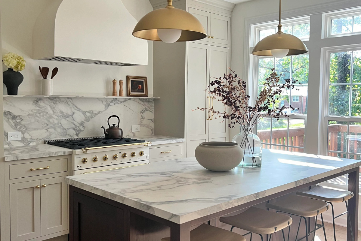 A kitchen with a large island and a stove top oven.