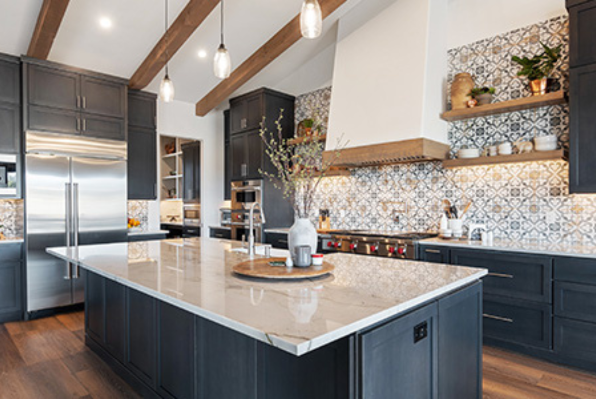 A kitchen with a large island and stainless steel appliances.