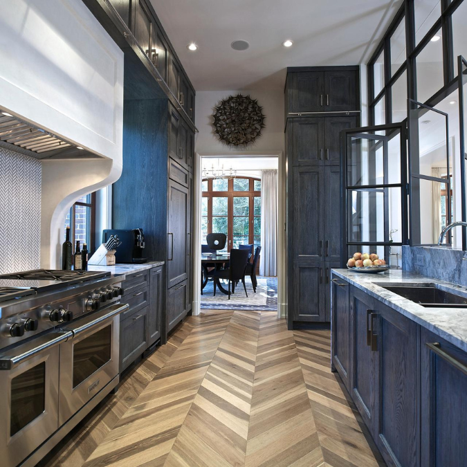 A kitchen with stainless steel appliances and blue cabinets