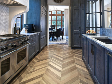 A kitchen with blue cabinets and stainless steel appliances