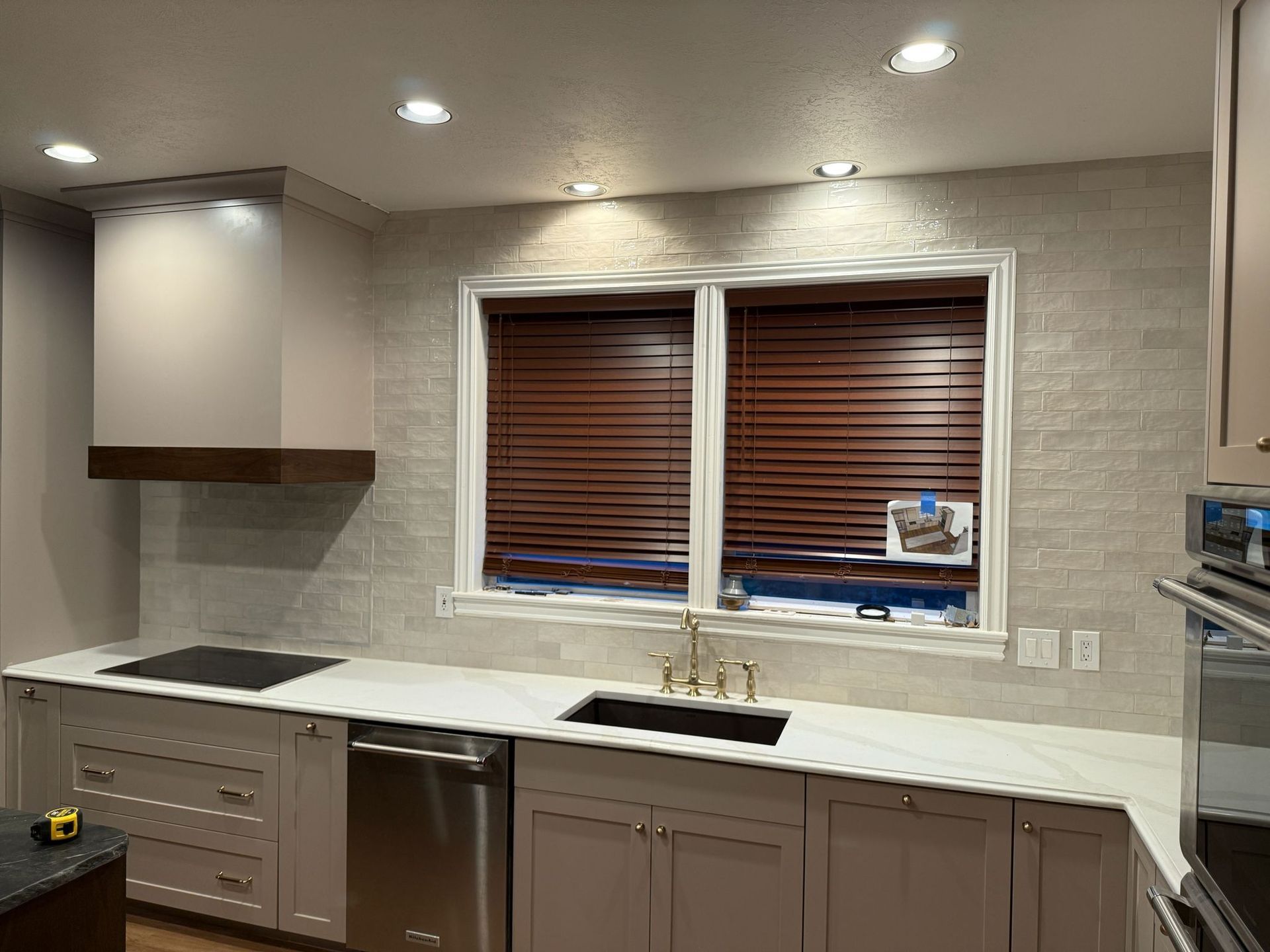 A bathroom with a walk in shower and a bench.