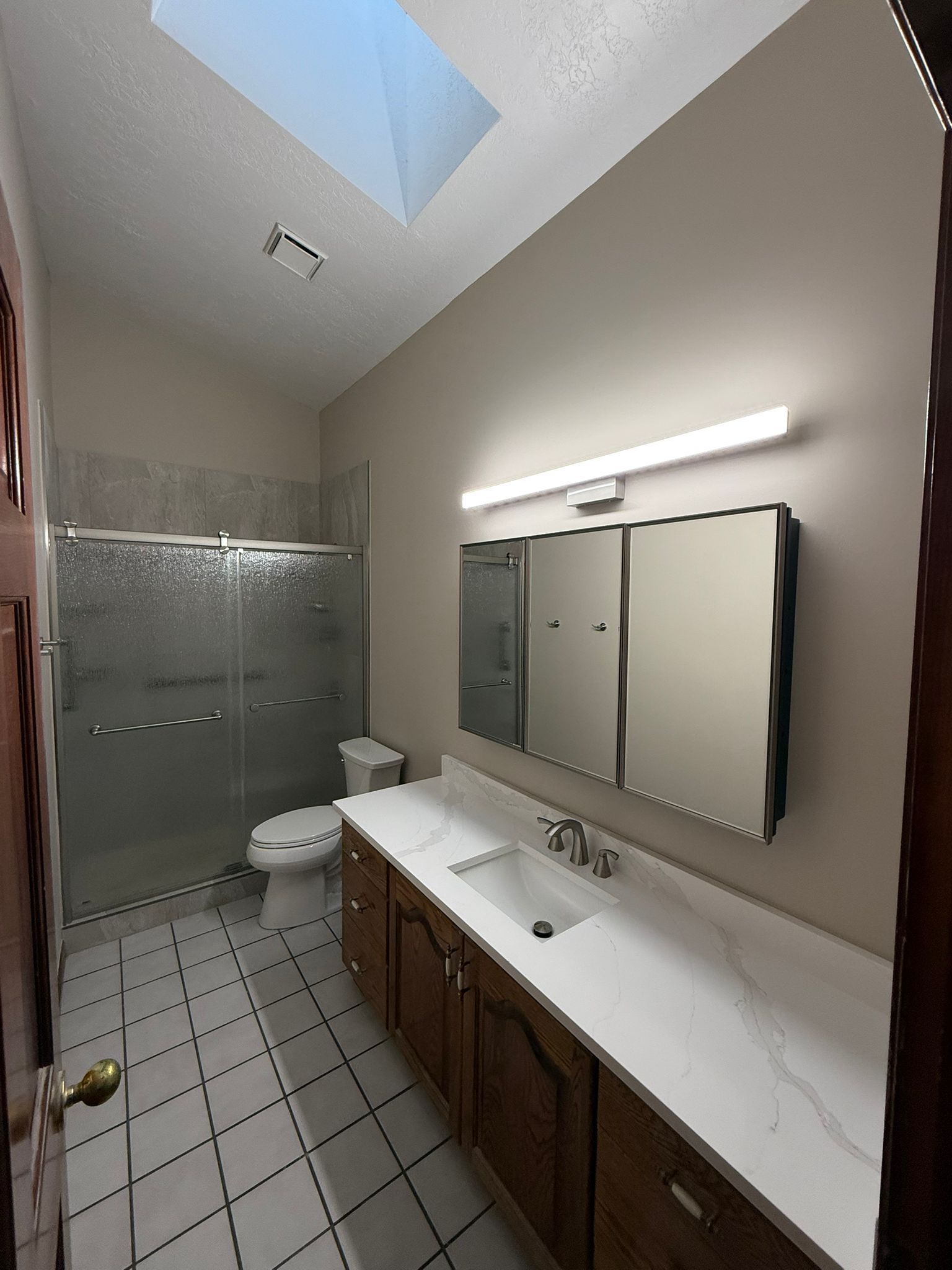 A bathroom with a sink , mirror and shower curtain