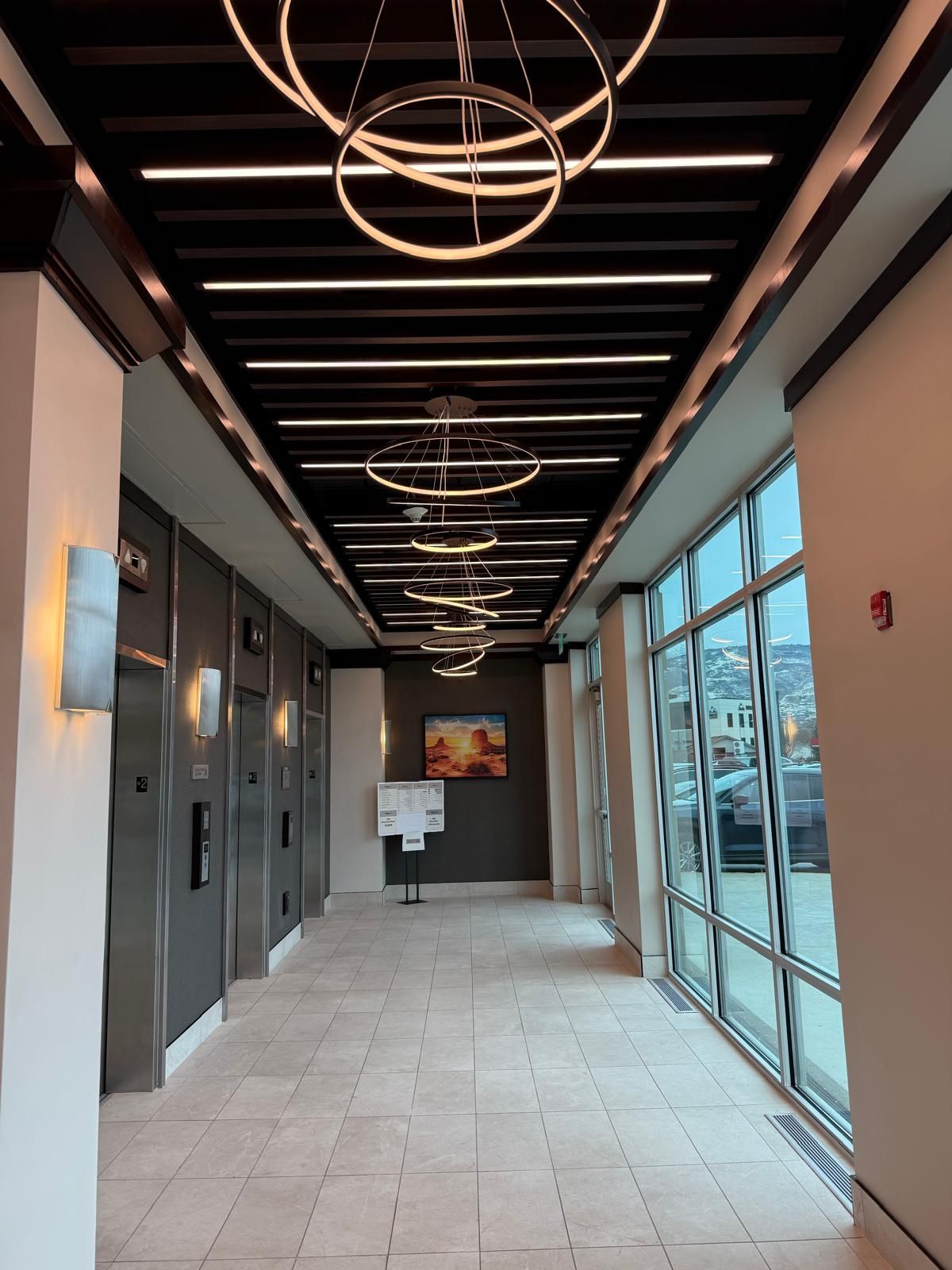 A kitchen with white cabinets , granite counter tops , stainless steel appliances and a large island.