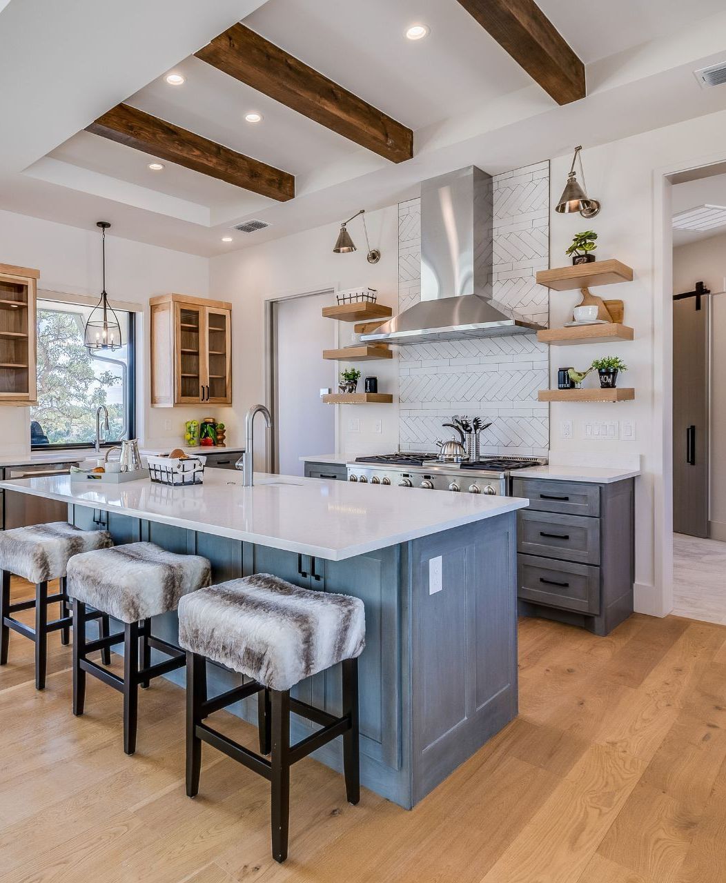 A kitchen with a large island and stools