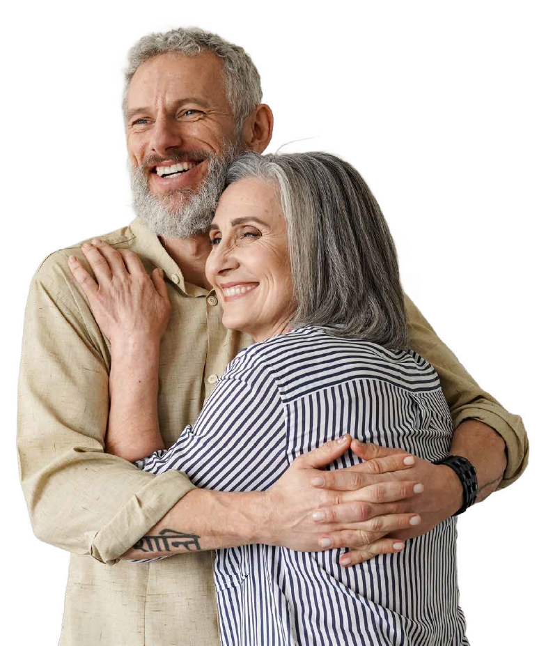 A man and a woman old enough for Medicare are hugging each other and smiling.