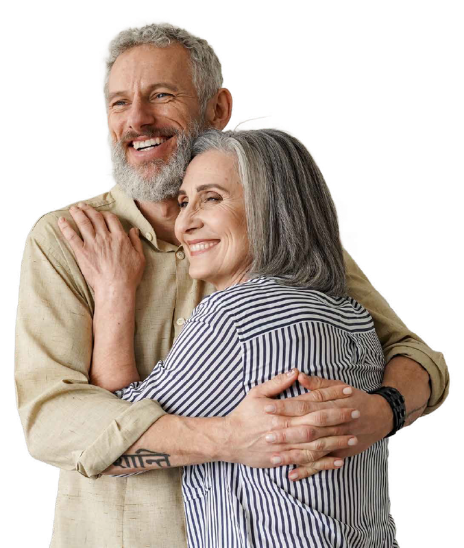 A man and a woman old enough for Medicare are hugging each other and smiling.