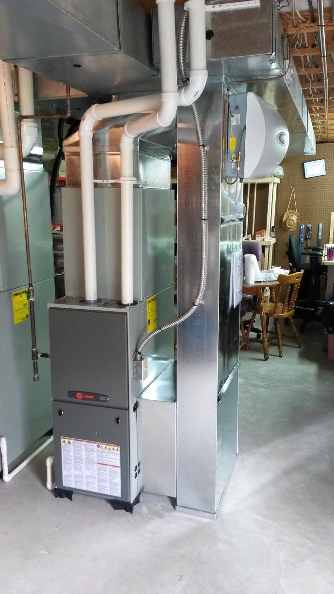 A heating and cooling system is installed in a basement in a house.