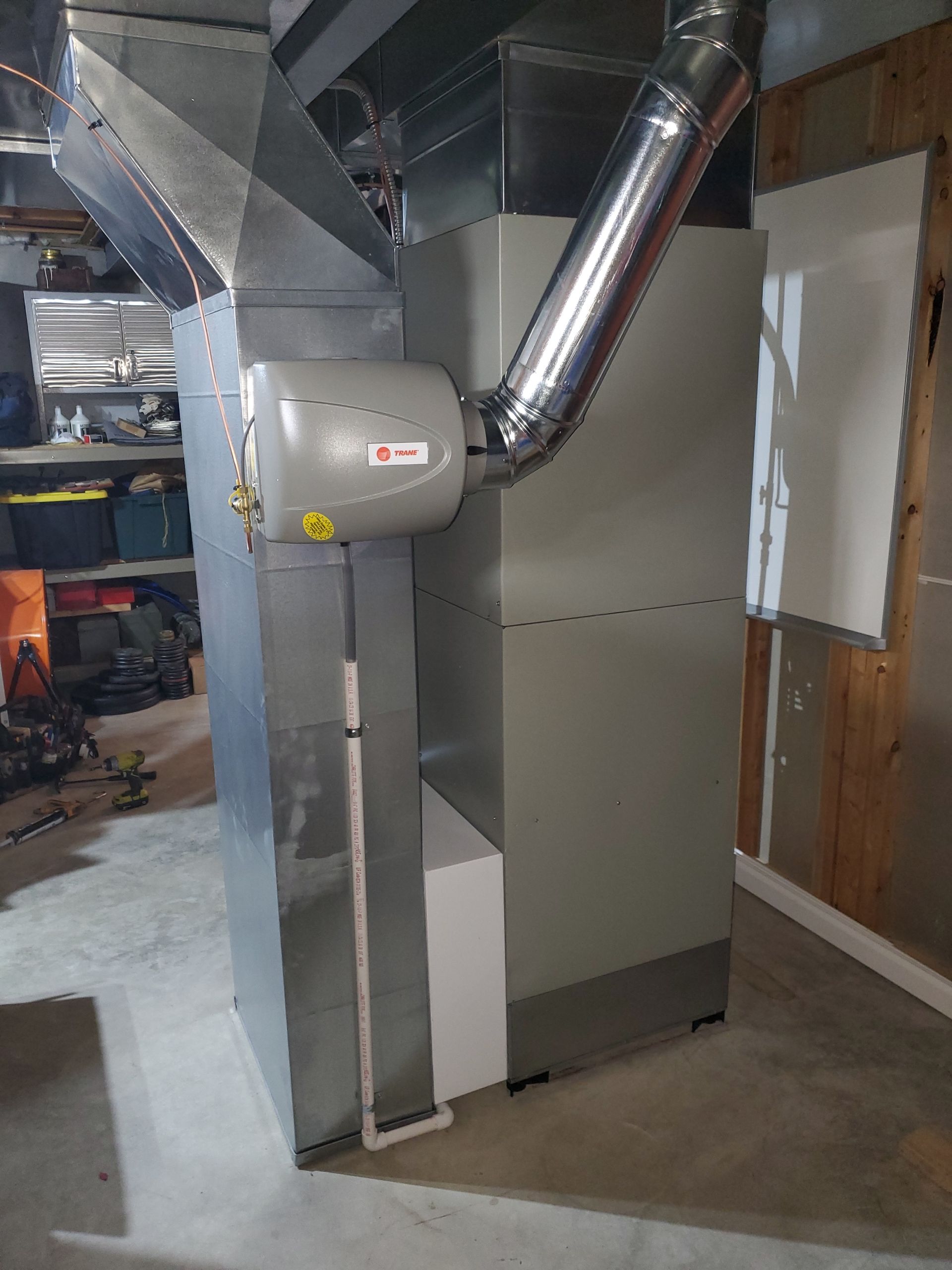 A stainless steel air conditioner and humidifier is installed in the basement.