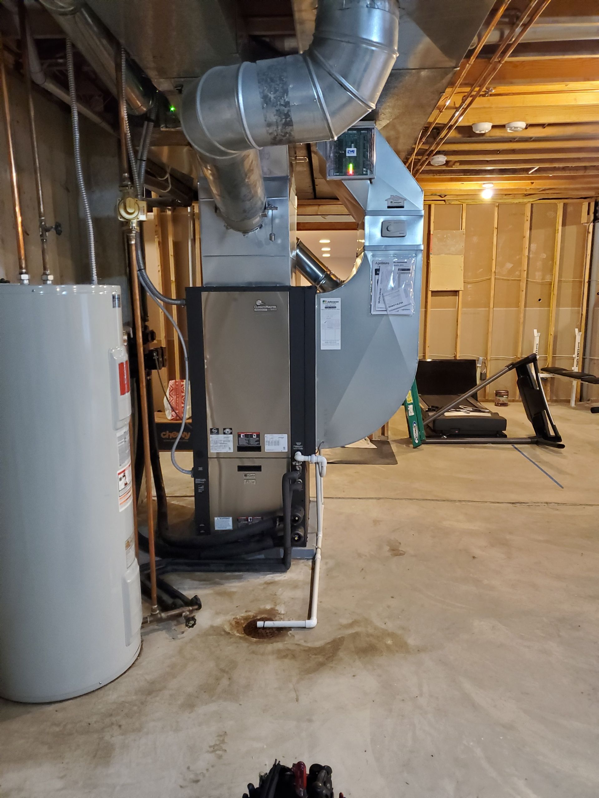 A basement with a water heater and a furnace.