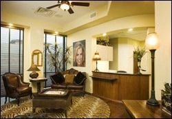 A living room filled with furniture and a ceiling fan.