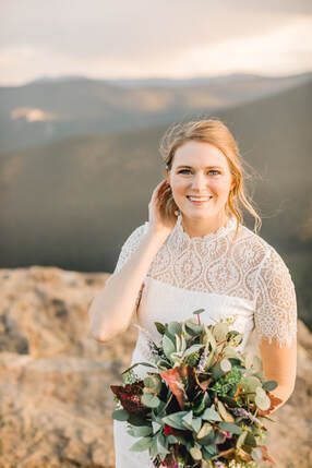 The bride is wearing a white lace dress and holding a bouquet of flowers.