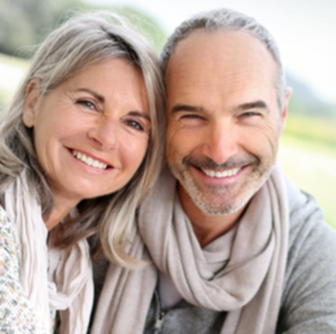 A man and a woman are smiling for the camera