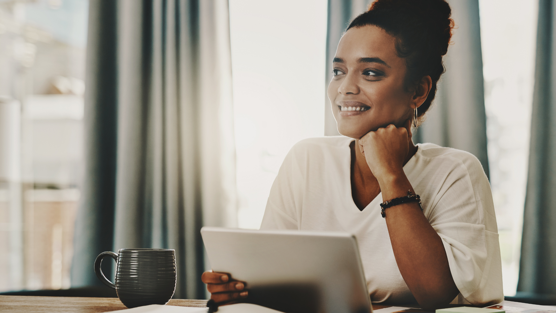 A person sitting against a window with a somber expression, their reflection visible on the rain-streaked glass.