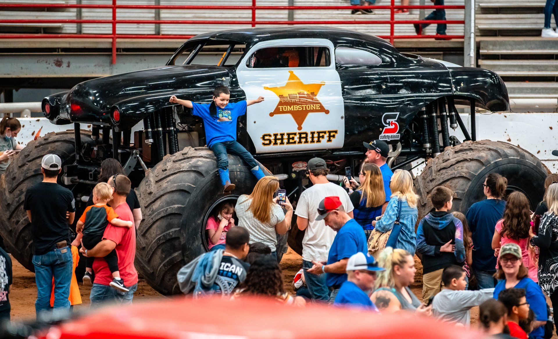 Family taking pictures with a monster truck
